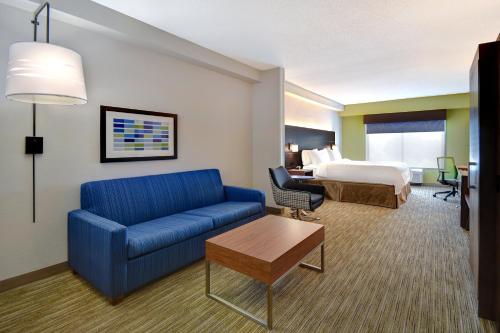 a hotel room with a couch and a bed at Holiday Inn Express Hotel & Suites Smyrna-Nashville Area by IHG in Smyrna