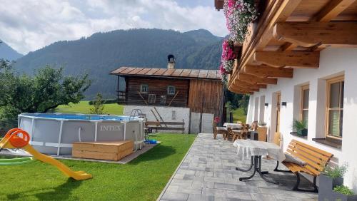 a backyard with a swimming pool and a house at Ferienwohnungen Egg in Fieberbrunn