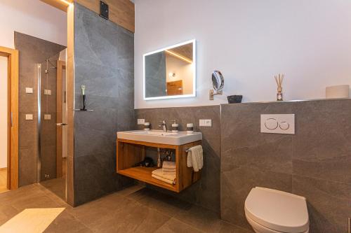 a bathroom with a sink and a toilet at Ferienwohnungen Egg in Fieberbrunn