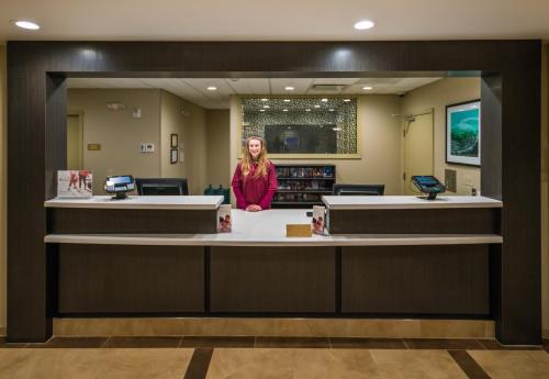 a woman standing behind a counter in a salon at Candlewood Suites - Fairbanks by IHG in Fairbanks