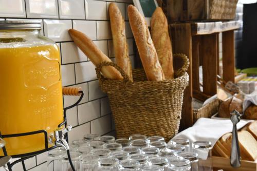 a basket of bread and a jar of orange juice at Holiday Inn Madrid - Las Tablas by IHG in Madrid