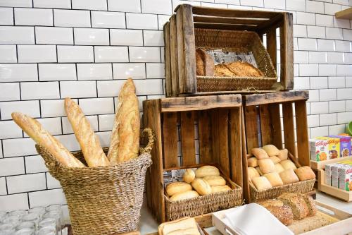 a bunch of breads in baskets on a counter at Holiday Inn Madrid - Las Tablas by IHG in Madrid