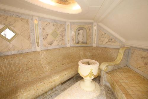 a bathroom with a tub and a toilet in it at 25h SPA-Residenz POOLs IN & OUT, private Garden & Beach in Neusiedl am See
