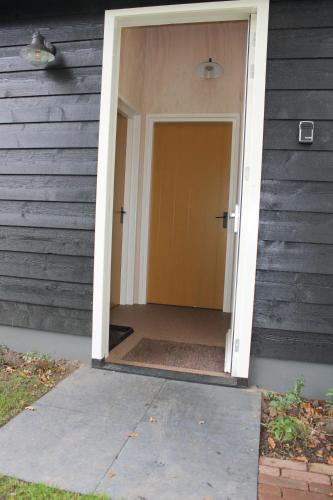 an open door of a house with a door at Halte Liempde Logies in Liempde