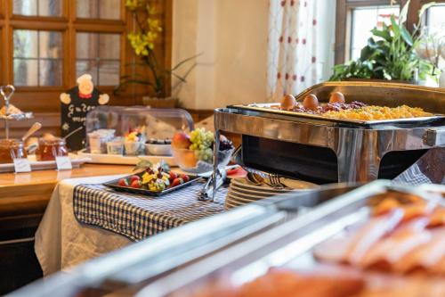 a buffet with many different types of food on a table at Landgasthof zum Erdinger Weissbräu in Rosenheim