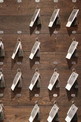 a group of tags on a wooden table at Hotel Saint-Louis Pigalle in Paris