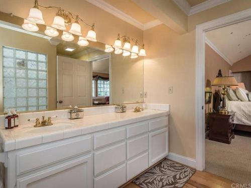 a bathroom with a sink and a large mirror at The Vineyard Farmhouse Villa in Paso Robles