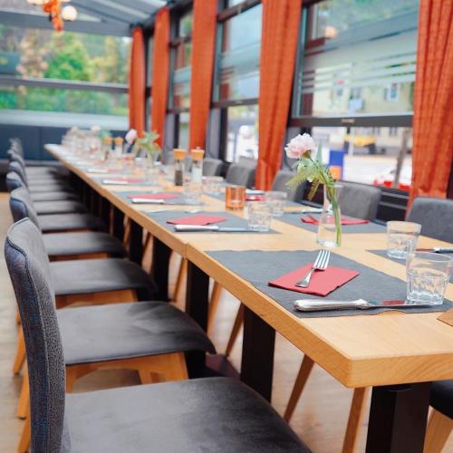 a long table in a restaurant with chairs and tables sidx sidx at Hotel Spatz in Luzern
