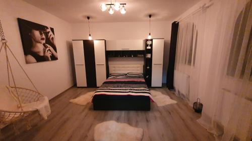 a bedroom with two beds and a swing at Casa mica Resita in Reşiţa