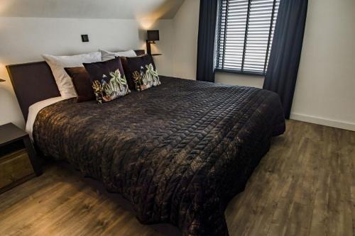 a bedroom with a large bed and a window at Luxexcellent super suite in Nuland
