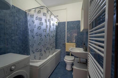 a bathroom with a sink and a tub and a toilet at Apartman Marija Imotski in Imotski