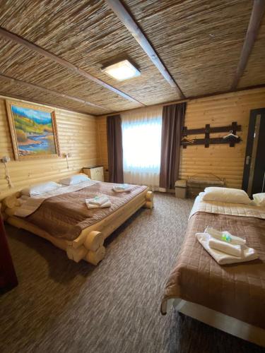 a hotel room with two beds and a window at Guest house Shulc in Mizhhirʼʼya