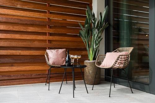 a patio with two chairs and a potted plant at Tavarneta Estate in Dobrovo