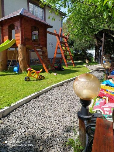 a backyard with a play yard with a play house at Guest house Shulc in Mizhhirʼʼya