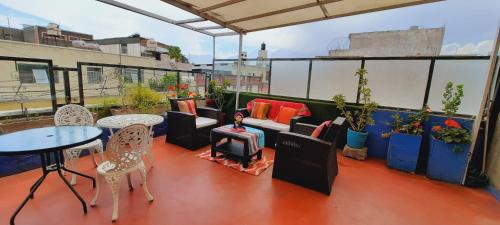 a patio with tables and chairs on a balcony at Chikan Hoteles in Arequipa