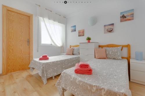A bed or beds in a room at Apartment with pool & balcony less than 10min walk to La Mata Beach!