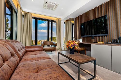 a living room with a couch and a table at Hotel Ub Aqua Park in Ub