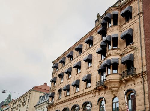 a large building with a bunch of windows on it at Moment Hotels in Malmö