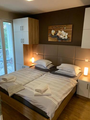 a bedroom with a large bed with two towels on it at Vila Apartment Bled Lake in Bled