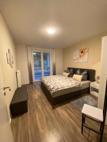 a bedroom with a bed and a large window at ferienwohnungen.ruhla in Ruhla
