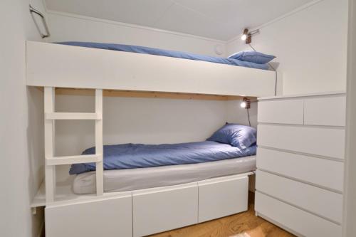 a bunk bed in a room with two beds at Volda Floating Home in Kvaløya