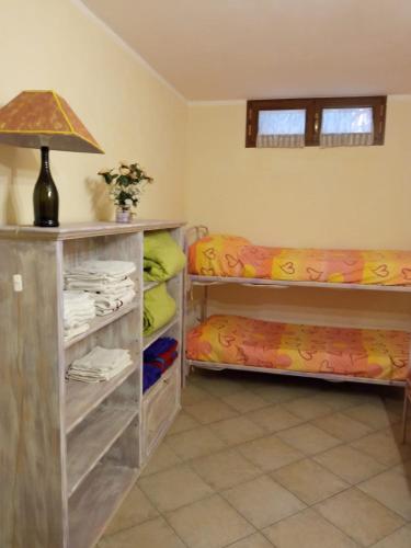 a room with two bunk beds and a lamp at " La casa di Elena " in Pietrasanta