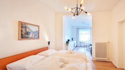 a bedroom with four white beds in it at Rosa Apartment with parking historic city center in Merano