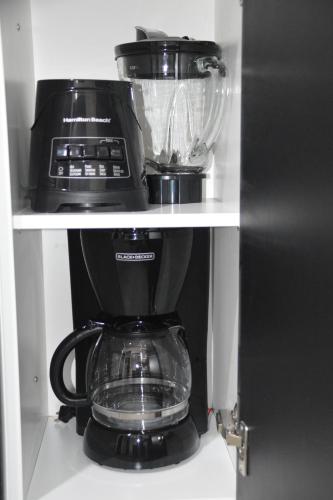 a coffee maker on a shelf in a kitchen at Cozy Stays Cayala Apartments 7 in Guatemala