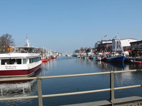 a group of boats are docked in a river at Ferienhaus nahe Ostsee und Wald in Neubukow