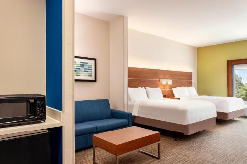 a hotel room with two beds and a tv at Holiday Inn Express & Suites Searcy by IHG in Searcy