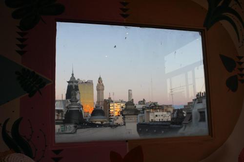 a view of a city skyline from a window at Parla Hostel in Buenos Aires
