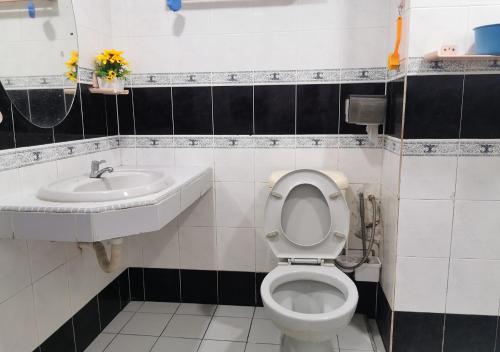 a bathroom with a toilet and a sink at 1-6Pax Port Dickson 2BR Glory Beach Resort Seaview in Port Dickson