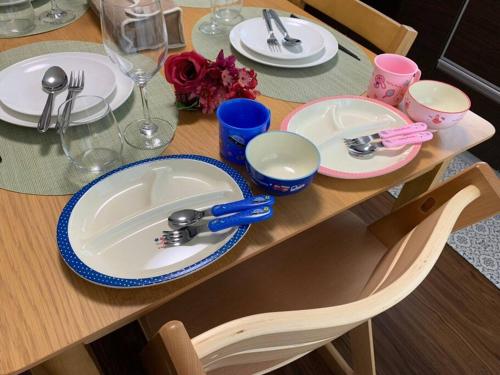 a table with a sink and plates on it at Nara Family HOUSE in Nara