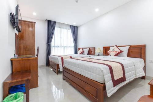 Postel nebo postele na pokoji v ubytování Bao Ngoc Hotel & Apt