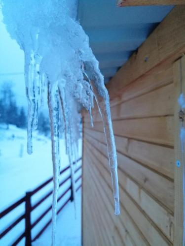 a icicle hanging from the ceiling of a log cabin at Brvnara Orfej in Gornje Pale