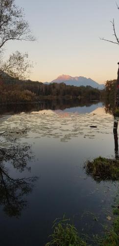 a large body of water with mountains in the background at Gîte clair, spacieux et cosy avec vue sur le massif de la Chartreuse in Sainte-Hélène-du-Lac