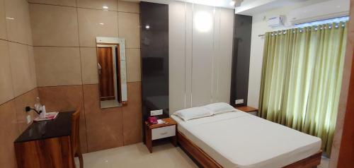 Tempat tidur dalam kamar di Sree Gokulam Sabari