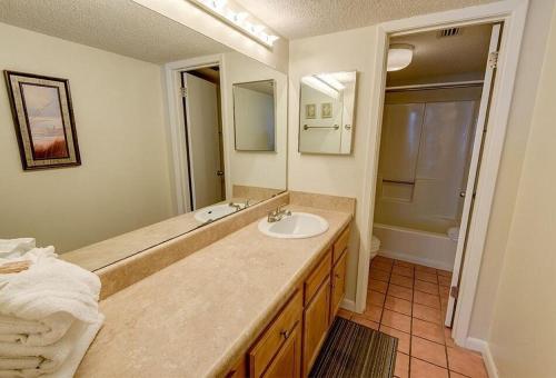 a bathroom with a sink and a large mirror at Phoenix II 2045 in Orange Beach