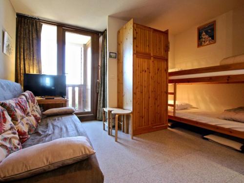 a living room with a couch and a bunk bed at Studio Chamrousse, 1 pièce, 4 personnes - FR-1-340-95 in Chamrousse