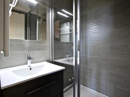 a bathroom with a sink and a mirror and a shower at Studio Chamrousse, 1 pièce, 4 personnes - FR-1-340-95 in Chamrousse