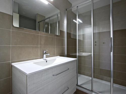 a bathroom with a sink and a shower at Studio Chamrousse, 1 pièce, 3 personnes - FR-1-340-92 in Chamrousse
