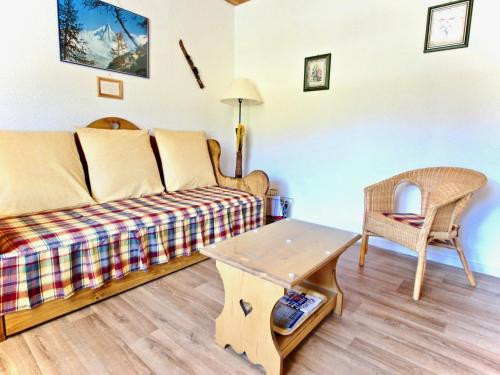 a living room with a couch and a table at Studio Chamrousse, 1 pièce, 4 personnes - FR-1-340-99 in Chamrousse