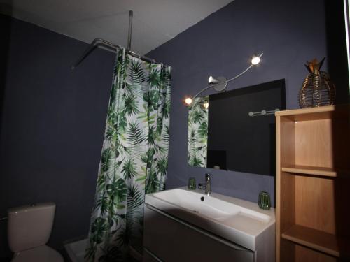 a bathroom with a sink and a shower curtain at Studio Chamrousse, 1 pièce, 4 personnes - FR-1-340-108 in Chamrousse