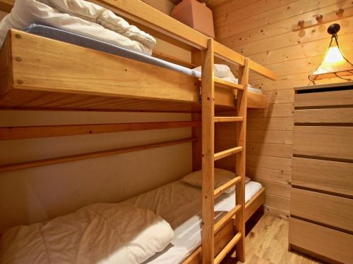 a bedroom with two bunk beds in a cabin at Studio Chamrousse, 1 pièce, 4 personnes - FR-1-549-22 in Chamrousse