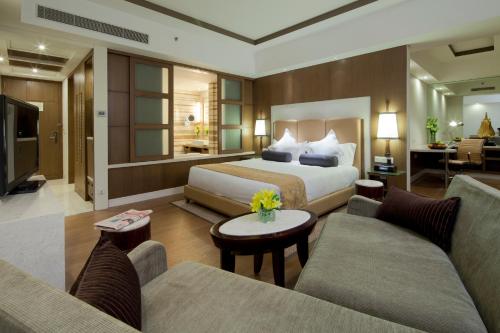 a hotel room with a bed and a living room at Crowne Plaza New Delhi Okhla, an IHG Hotel in New Delhi