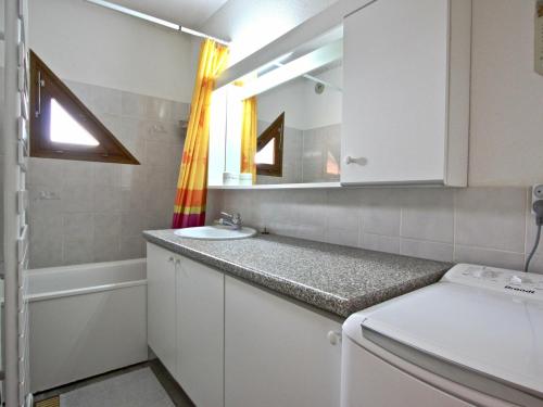 a bathroom with a sink and a mirror at Appartement Chamrousse, 2 pièces, 4 personnes - FR-1-340-210 in Chamrousse