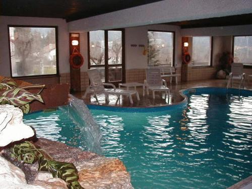 a large swimming pool in a hotel room at Club Hotel Alpino in Folgaria