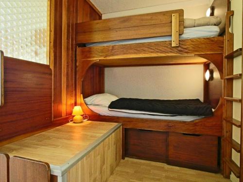 a room with two bunk beds and a table at Studio Chamrousse, 1 pièce, 4 personnes - FR-1-549-48 in Chamrousse