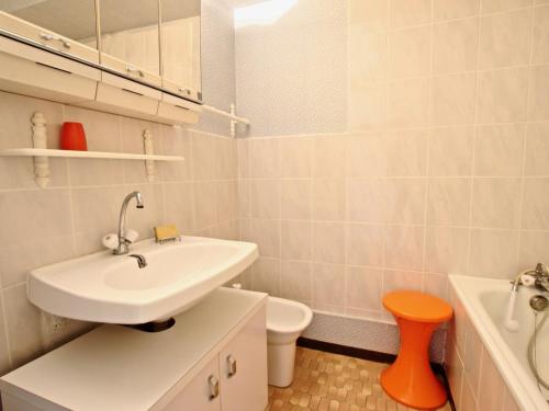 a white bathroom with a sink and a toilet at Studio Chamrousse, 1 pièce, 3 personnes - FR-1-549-35 in Chamrousse