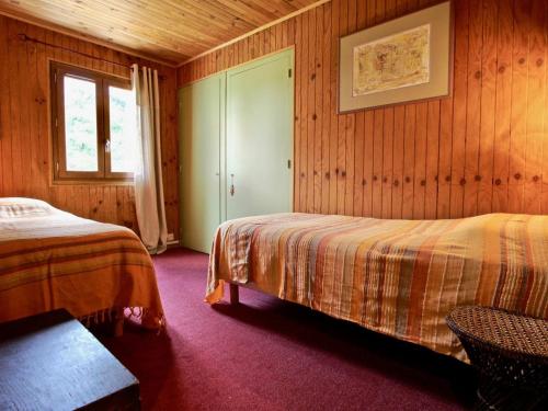 a bedroom with two beds and a window at Appartement Chamrousse, 4 pièces, 8 personnes - FR-1-340-232 in Chamrousse